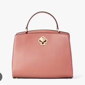 Pink Kate Spade bag with heart/spade clasp. Super cute.